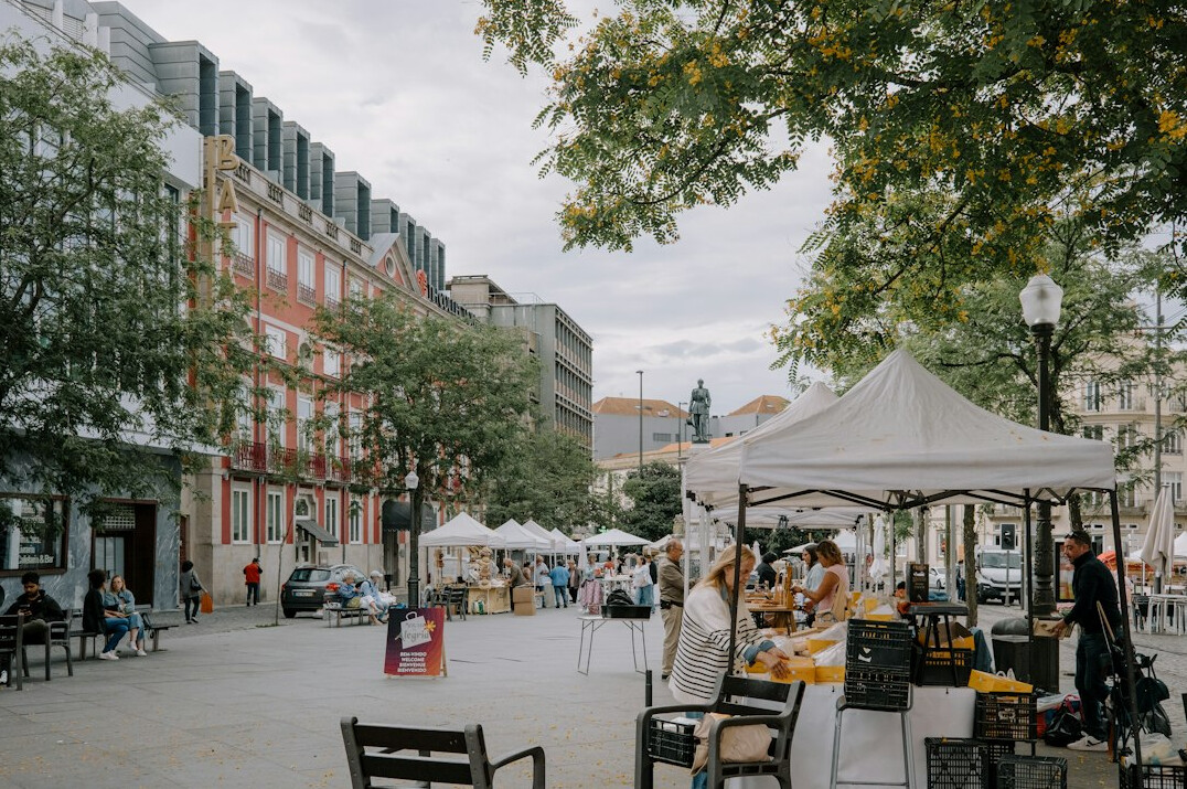 Vibrant outdoor farmers market on a city street with vendor stalls